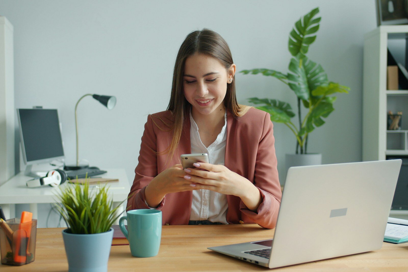 Small business owner smiling while checking new bookings on her phone